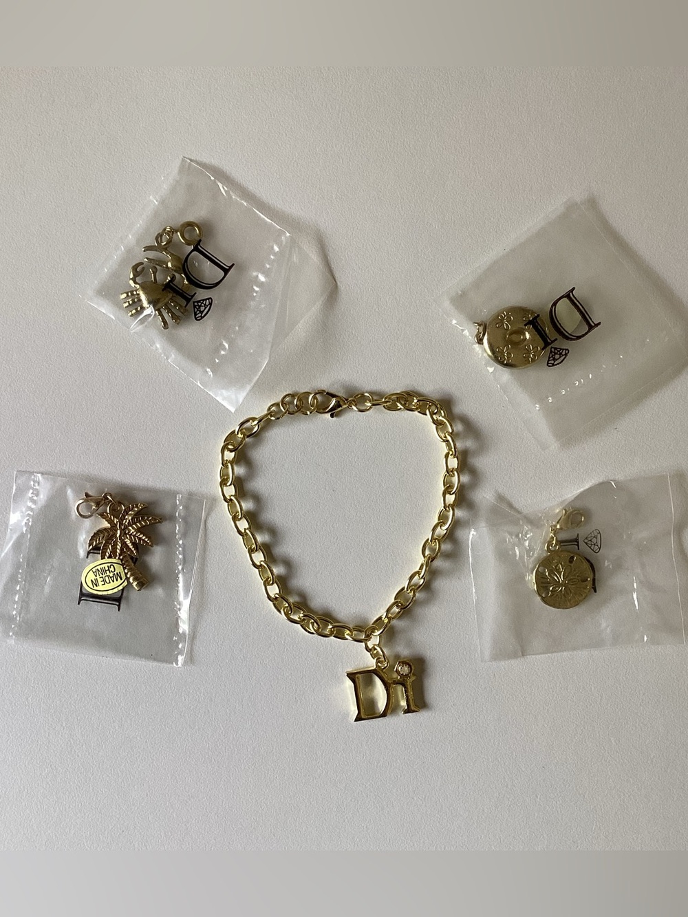 Diamonds International Gold Tone Charm Bracelet and 4 Charms
